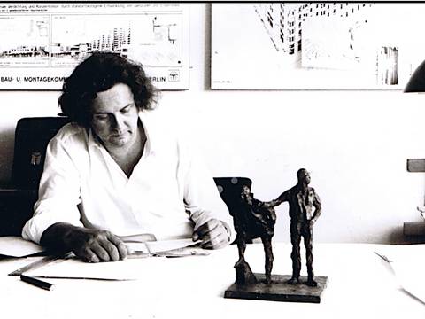 Wolf R. Eisentraut am Zeichentisch mit dem Modell des Denkmals der Erbauer Marzahns, 1987