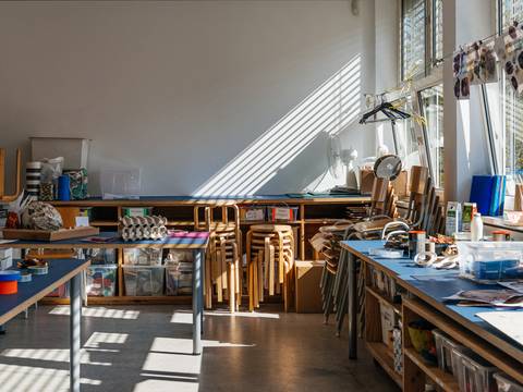 Das Atelier Bunter Jakob in der Berlinischen Galerie – Foto: Blick in das Atelier Bunter Jakob mit Werktischen, gestapelten Hockern und viel Material zum kreativen Arbeiten.