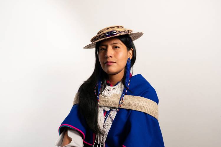 Embodied Practices – Talk über Körperwissen 2 – Porträt von Julieth Morales in blauer traditioneller Kleidung mit Hut vor hellem Hintergrund