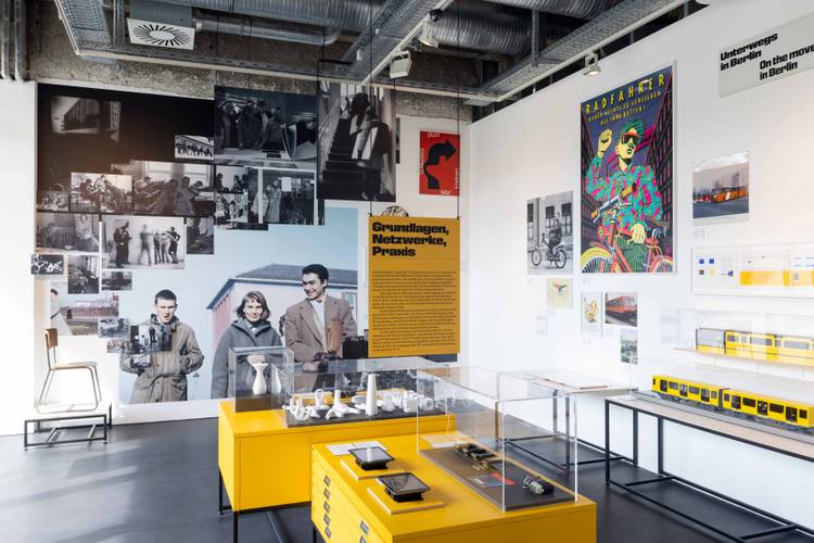 Ausstellungsansicht „Gestalten für Berlin. Design aus der Kunsthochschule Berlin-Weißensee“ – Ausstellungsansicht mit verschiedenen Exponaten, sowie großformatigen historischen Fotografien