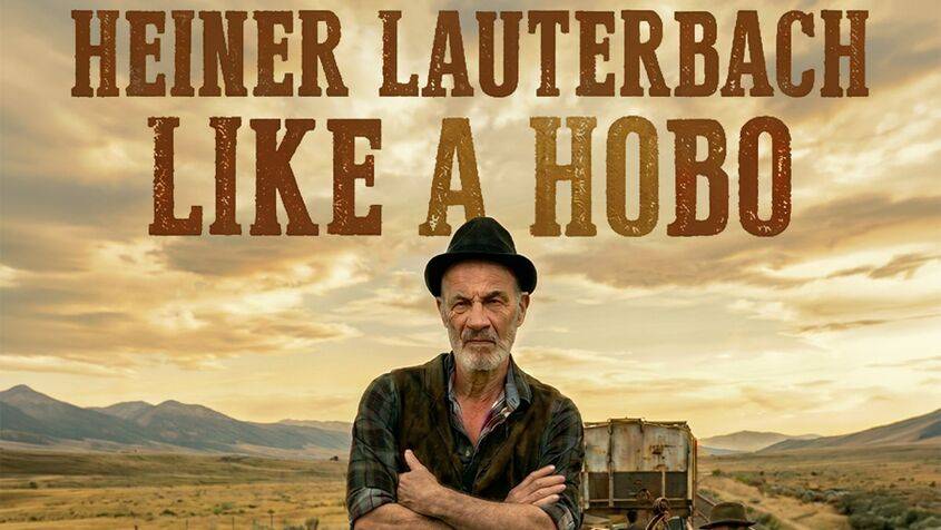 Mann mit Hut und verschränkten Armen vor ländlicher Landschaft. Text: HEINER LAUTERBACH LIKE A HOBO. Im Hintergrund Berge und Wolken.