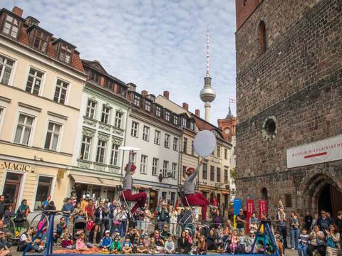 Der Wanderzirkus CABUWAZI bringt die Besucher:innen des Nikolaiviertels zum Staunen. – Der Wanderzirkus CABUWAZI während einer Show auf dem Nikolaikirchplatz