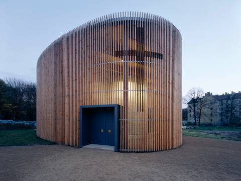 Reitermann / Sassenroth, Kapelle der Versöhnung, 1996–2000 – Außenansicht der Kapelle der Versöhnung in Berlin. Die Architektur der Kapelle ist schlicht und besteht aus einer hölzernen Außenkonstruktion mit blauer Eingangstür und einem Lehmbau im Inneren.