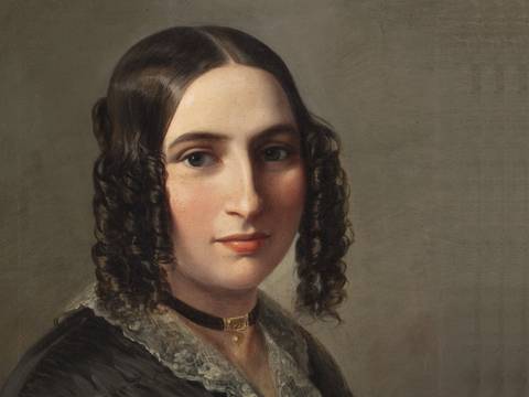 Fanny Hensel – Person mit langen lockigen Haaren und heller Haut, trägt eine schwarze Kleidung mit Spitzenkragen und ein dunkles Halsband mit goldfarbenem Anhänger.